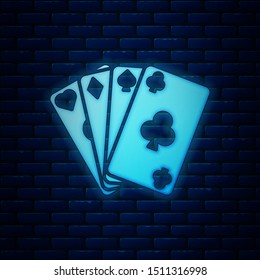Glowing neon Playing cards icon isolated on brick wall background. Casino gambling.  Vector Illustration