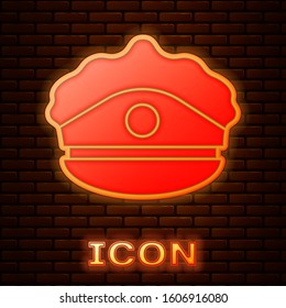 Glowing neon Police cap with cockade icon isolated on brick wall background. Police hat sign.  Vector Illustration