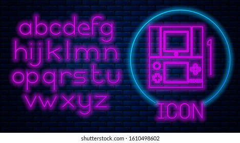 Glowing neon Portable video game console icon isolated on brick wall background. Gamepad sign. Gaming concept. Neon light alphabet. Vector Illustration