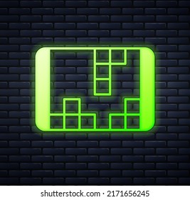 Glowing neon Portable video game console icon isolated on brick wall background. Handheld console gaming.  Vector