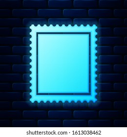 Glowing neon Postal stamp icon isolated on brick wall background.  Vector Illustration