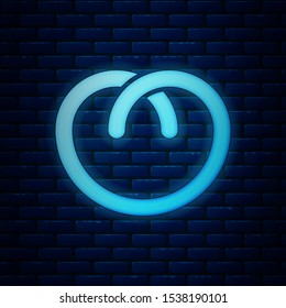 Glowing neon Pretzel icon isolated on brick wall background. German comfort food pastry. Oktoberfest festival.  Vector Illustration
