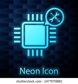 Glowing neon Processor with screwdriver and wrench icon isolated on brick wall background. Adjusting, service, setting, maintenance, repair, fixing.  Vector Illustration