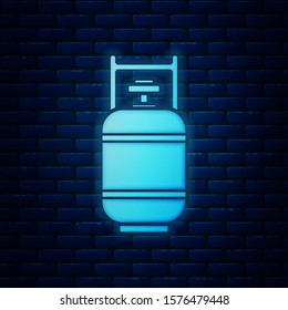 Glowing neon Propane gas tank icon isolated on brick wall background. Flammable gas tank icon.  Vector Illustration