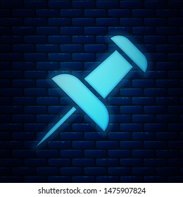 Glowing neon Push pin icon isolated on brick wall background. Thumbtacks sign.  Vector Illustration