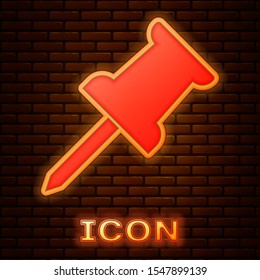 Glowing neon Push pin icon isolated on brick wall background. Thumbtacks sign.  Vector Illustration