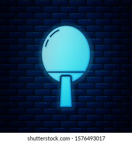Glowing neon Racket for playing table tennis icon isolated on brick wall background.  Vector Illustration