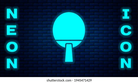 Glowing neon Racket for playing table tennis icon isolated on brick wall background.  Vector