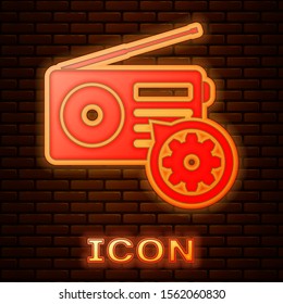 Glowing neon Radio with antenna and gear icon isolated on brick wall background. Adjusting app, service concept, setting options, maintenance, repair, fixing.  Vector Illustration