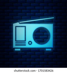 Glowing neon Radio with antenna icon isolated on brick wall background.  Vector Illustration