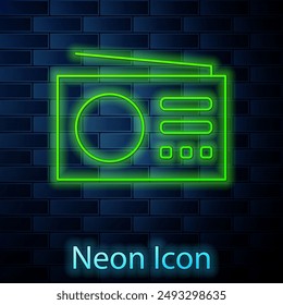Glowing neon Radio with antenna icon isolated on brick wall background.  Vector