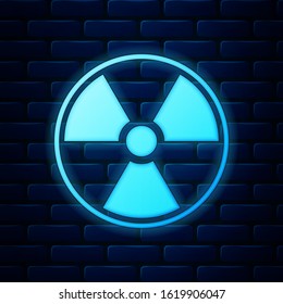 Glowing neon Radioactive icon isolated on brick wall background. Radioactive toxic symbol. Radiation Hazard sign.  Vector Illustration