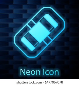 Glowing neon Rafting boat icon isolated on brick wall background. Inflatable boat.  Vector Illustration