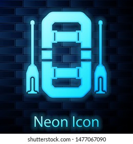 Glowing neon Rafting boat icon isolated on brick wall background. Inflatable boat with oars.  Vector Illustration