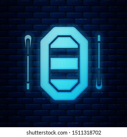 Glowing neon Rafting boat icon isolated on brick wall background. Inflatable boat with paddles. Water sports, extreme sports, holiday, vacation.  Vector Illustration