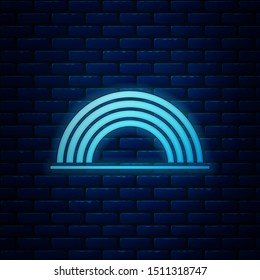 Glowing neon Rainbow with clouds icon isolated on brick wall background.  Vector Illustration