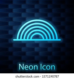 Glowing neon Rainbow with clouds icon isolated on brick wall background.  Vector Illustration