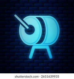 Glowing neon Ramadan drum icon isolated on brick wall background.  Vector