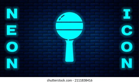 Glowing neon Rattle baby toy icon isolated on brick wall background. Beanbag sign.  Vector