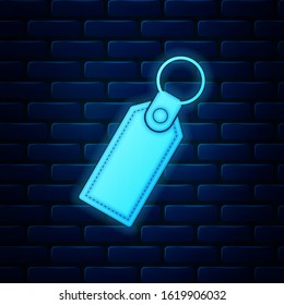 Glowing neon Rectangular key chain with ring for key icon isolated on brick wall background.  Vector Illustration