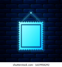 Glowing neon Rectangular picture frame hanging on the wall icon isolated on brick wall background.  Vector Illustration