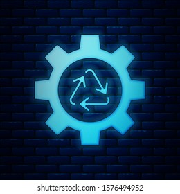 Glowing neon Recycle symbol and gear icon isolated on brick wall background. Circular arrow icon. Environment recyclable go green.  Vector Illustration