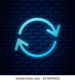 Glowing neon Refresh icon isolated on brick wall background. Reload symbol. Rotation arrows in a circle sign.  Vector Illustration