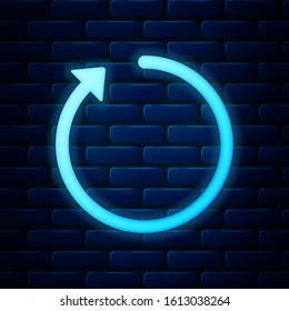 Glowing neon Refresh icon isolated on brick wall background.  Vector Illustration