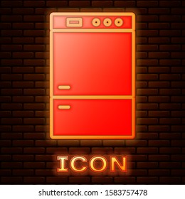 Glowing neon Refrigerator icon isolated on brick wall background. Fridge freezer refrigerator. Household tech and appliances.  Vector Illustration