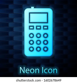 Glowing neon Remote control icon isolated on brick wall background.  Vector Illustration