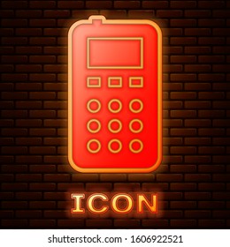 Glowing neon Remote control icon isolated on brick wall background.  Vector Illustration