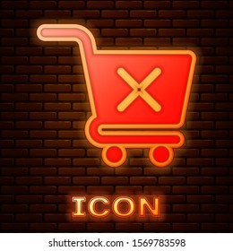 Glowing neon Remove shopping cart icon isolated on brick wall background. Online buying concept. Delivery service sign. Supermarket basket and X mark.  Vector Illustration