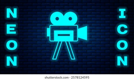 Glowing neon Retro cinema camera icon isolated on brick wall background. Video camera. Movie sign. Film projector.  Vector