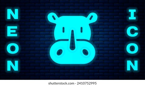 Glowing neon Rhinoceros icon isolated on brick wall background. Animal symbol.  Vector