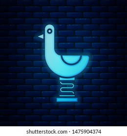 Glowing neon Riding kid duck icon isolated on brick wall background.  Vector Illustration