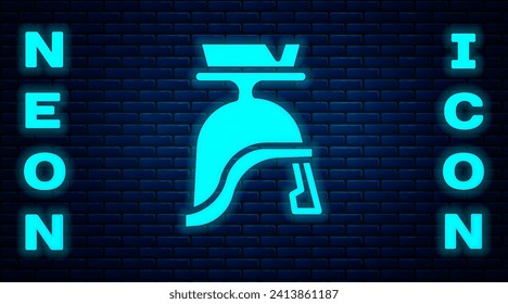 Glowing neon Roman army helmet icon isolated on brick wall background.  Vector