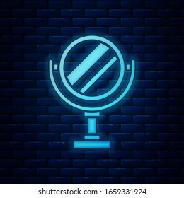 Glowing neon Round makeup mirror icon isolated on brick wall background.  Vector Illustration
