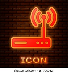 Glowing neon Router and wi-fi signal symbol icon isolated on brick wall background. Wireless ethernet modem router. Computer technology internet.  Vector Illustration