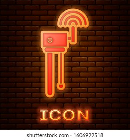 Glowing neon Router and wi-fi signal symbol icon isolated on brick wall background. Wireless ethernet modem router. Computer technology internet.  Vector Illustration