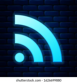 Glowing neon RSS icon isolated on brick wall background. Radio signal. RSS feed symbol.  Vector Illustration