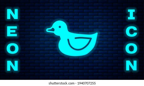 Glowing neon Rubber duck icon isolated on brick wall background.  Vector