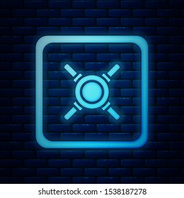Glowing neon Safe icon isolated on brick wall background. The door safe a bank vault with a combination lock. Reliable Data Protection.  Vector Illustration