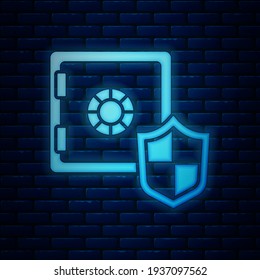 Glowing neon Safe with shield icon isolated on brick wall background. Insurance concept. Security, safety, protection, protect concept.  Vector
