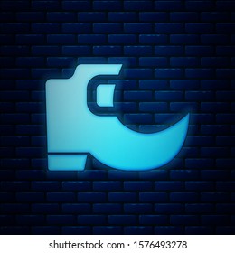 Glowing neon Saint Patricks day irish tradition leprechaun boots icon isolated on brick wall background.  Vector Illustration