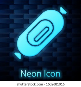 Glowing neon Salami sausage icon isolated on brick wall background. Meat delicatessen product.  Vector Illustration