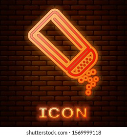 Glowing neon Salt and pepper icon isolated on brick wall background. Cooking spices.  Vector Illustration