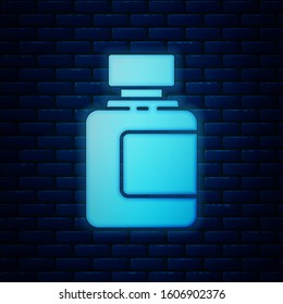 Glowing neon Sauce bottle icon isolated on brick wall background. Ketchup, mustard and mayonnaise bottles with sauce for fast food.  Vector Illustration