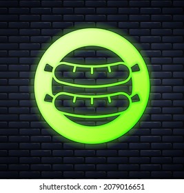 Glowing neon Sausage icon isolated on brick wall background. Grilled sausage and aroma sign.  Vector