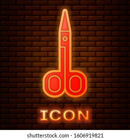 Glowing neon Scissors icon isolated on brick wall background. Cutting tool sign.  Vector Illustration