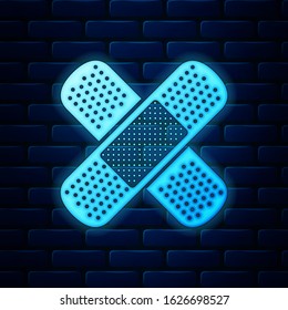 Glowing neon Set Bandage plaster icon isolated on brick wall background. Medical plaster, adhesive bandage, flexible fabric bandage.  Vector Illustration